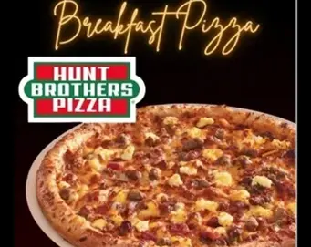 A Hunt Brothers Pizza advertisement featuring a breakfast pizza topped with eggs, cheese, and meat on a dark background.