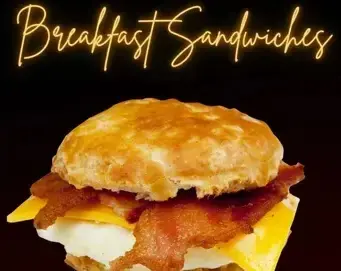 A breakfast sandwich with bacon, egg, and cheese on a biscuit, under the text "Breakfast Sandwiches.