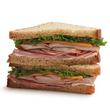 Stacked turkey and ham sandwich with lettuce and cheese between three slices of multigrain bread.