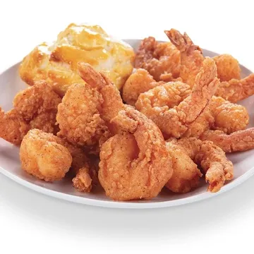 A white plate with golden fried shrimp and a side of cheesy mashed potatoes.